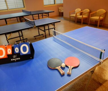 Indoor ping pong setup with paddles and scoreboard at Park Hotel Miyabitei Hokkaido ryokan recreation room
