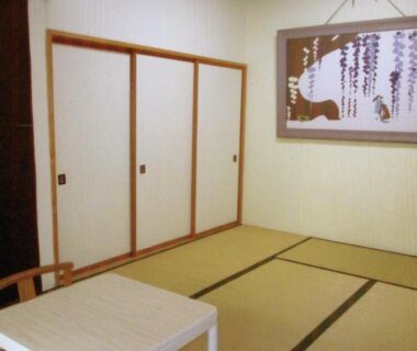Tatami room with low table and sliding fusuma doors at Pension Hakuba 70 in Nagano, Chūbu