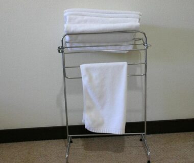 Folded white towels on a metal rack inside Pension Marie, Yamanashi, Chūbu