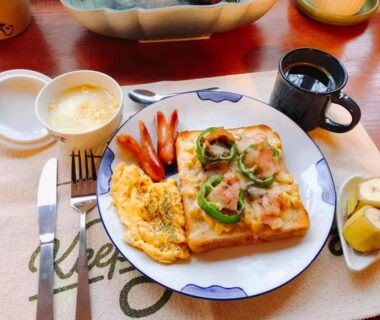 Toast with cheese and peppers, scrambled eggs, sausages, coffee and yogurt at Pension Marie in Yamanashi, Chūbu