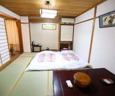 Futon on tatami floor with low table and shoji screens at Rakki OnsenRyokan, Nagano, Chūbu