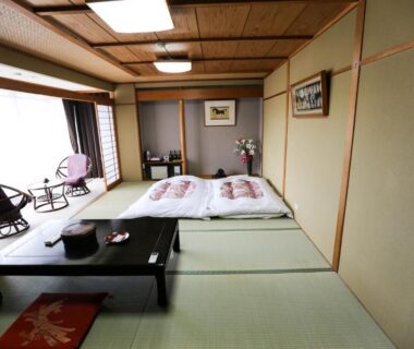 Tatami room with futons and low table at Rakki OnsenRyokan in Nagano, Chūbu, Japan