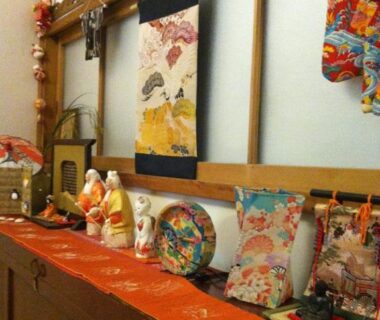 Shelf with hina dolls, kakejiku scroll and colorful textiles in Rakucho Ryokan interior, Kyoto