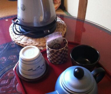 Kettle and teapot on lacquer tray in tatami room at Rakucho Ryokan, Kyoto