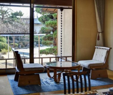 Japanese tatami room with low tables and chairs overlooking garden at Rakusuien in Yamanashi Chubu Japan