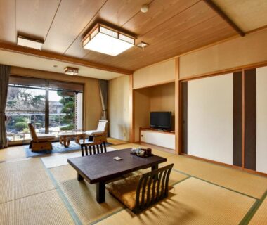 Spacious tatami room with low table and garden view at Rakusuien, Yamanashi, Chūbu Japan