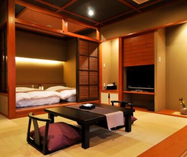 Traditional tatami room with low table, zabuton cushions and futon bedding at Rakuyu in Yamanashi Chūbu