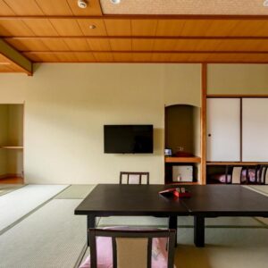 Traditional tatami room with low table, floor chairs, shoji screens and sliding doors at Rantei in Miyagi Tohoku