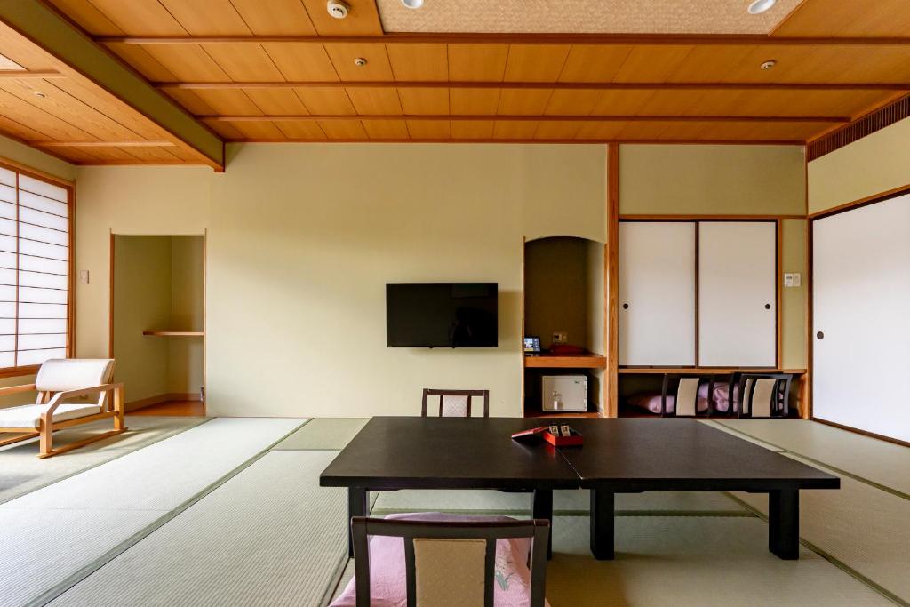 Tatami Room at Rantei Miyagi Tohoku Traditional tatami room with low table, floor chairs, shoji screens and sliding doors at Rantei in Miyagi Tohoku