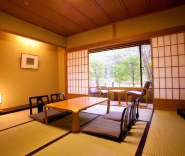 Traditional tatami room with low table, shoji screens and garden view at Ranzan in Kyoto, Kansai