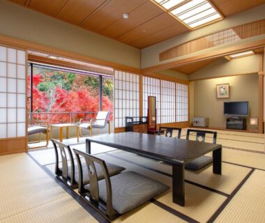 Traditional tatami room with low dining table, shoji screens and garden view at Ranzan in Kyoto, Kansai