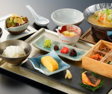 Traditional Japanese breakfast tray with rice, tamagoyaki, pickles and simmered dishes at Resorpia Beppu, Ōita