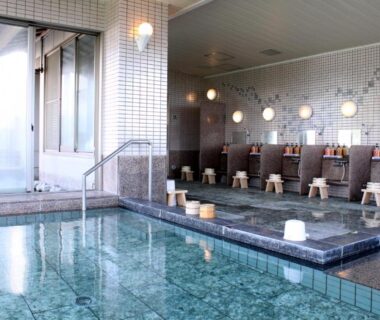 Indoor communal bathing area with tiled pool and washing stations at Resort Hills Toyohama Soranokaze, Mie, Kansai