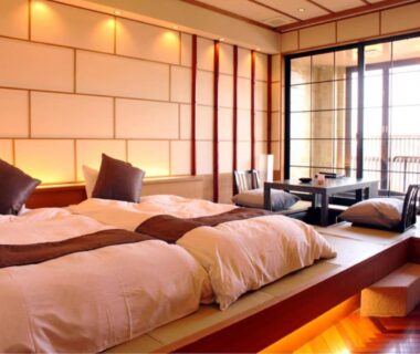 Raised tatami room with twin beds, shoji screens and low seating at Resort Hills Toyohama in Mie, Kansai Japan