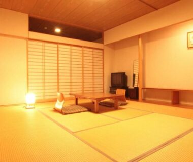 Tatami room with low table, cushions and shoji screens at Resort Project Myoko in Niigata, Chubu