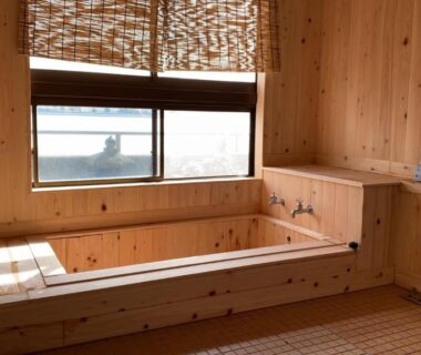 Wooden bathing area with tub and window at Riverside Hotel Karatsu Castle, Saga, Kyūshū, Japan