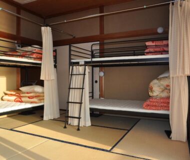 Tatami room with bunk beds, futon bedding, shoji screens and ladders at Riverside Hotel Karatsu Castle in Saga