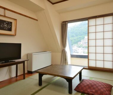 Tatami room with low table, shoji screen and balcony view at Riverside Uedakan, Nagano, Chūbu
