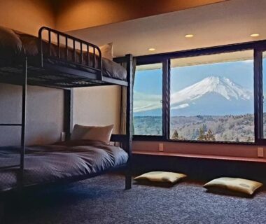 Bunk beds and floor cushions by window with Mount Fuji view at Rokumeikan Hills, Yamanashi