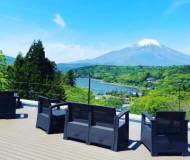 Outdoor terrace chairs overlooking river and snow-capped peak at Rokumeikan Hills, Yamanashi, Chūbu, Japan