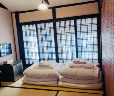 Tatami mats with folded futons and shoji screens at Roman Kan in Kyoto