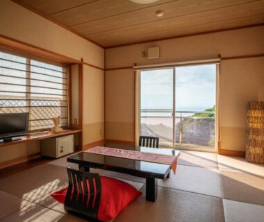 Traditional tatami room with low table and balcony overlooking sea, Rurika Shizuoka