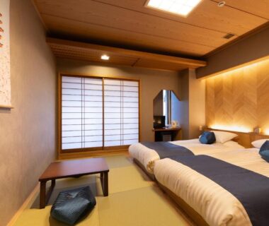 Tatami room with low twin futons, shoji screen and small table at Ryokan Asakusa Shigetsu, Tokyo