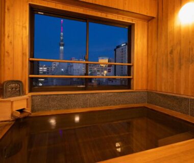 Indoor wooden bath with Tokyo Skytree view at Ryokan Asakusa Shigetsu