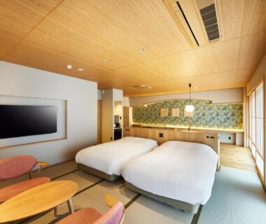 Tatami-floored twin room with low table, shoji doors and wooden ceiling at Ryokan Asukasou Nara