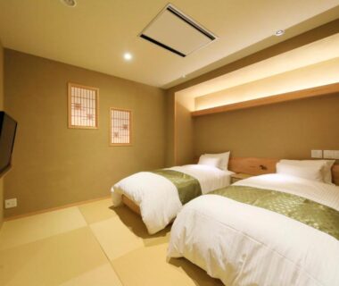 Tatami room with twin beds and shoji panels at Ryokan Biyunoyado in Nagano, Chūbu