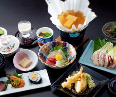 Assorted sashimi, tempura, simmering hot pot and side dishes on lacquer trays at Ryokan Chinsen-Rou Kyoto