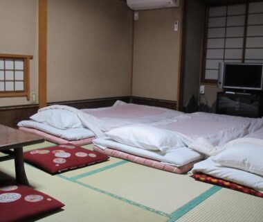Tatami room with futons and low table at Ryokan Fuji in Tokyo, Kantō, Japan