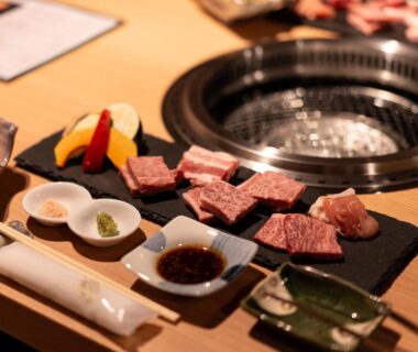 Sliced beef and dipping sauces beside a tabletop grill at Ryokan Gizan in Gifu, Chūbu, Japan