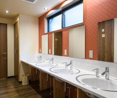 Communal wash area with multiple sinks and mirrors at Ryokan Ichinao in Tokyo, Kantō, Japan