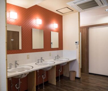 Row of sinks and mirrors in shared bathroom at Ryokan Ichinao Tokyo