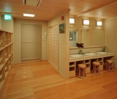 Wooden changing room with sinks, stools and lockers at Ryokan Ichinomatsu in Hokkaidō, Japan