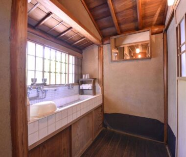 Rustic tiled wash basin and wooden ceiling at Ryokan Inakatei in Kyoto Kansai