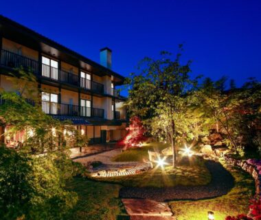 Evening illuminated garden courtyard with stone path at Ryokan KANADE exterior Kyoto Kansai