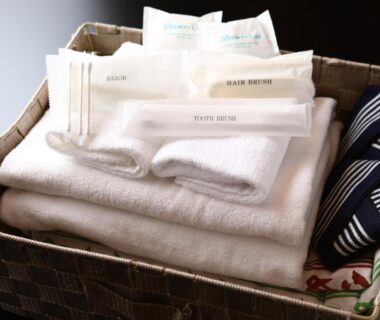 Folded white towels and toiletries in basket at Ryokan Kamogawa Asakusa Tokyo