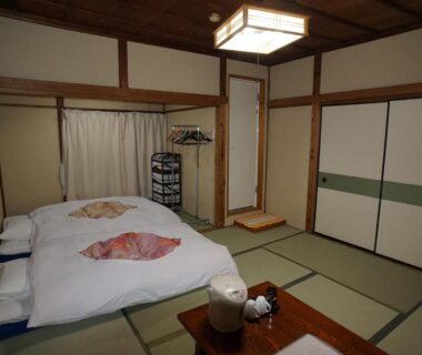 Traditional tatami room with futon bedding and low table at Ryokan Katsutaro in Tokyo