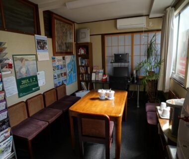 Small guest lounge with table, chairs and brochures at Ryokan Katsutaro in Tokyo, Kantō, Japan