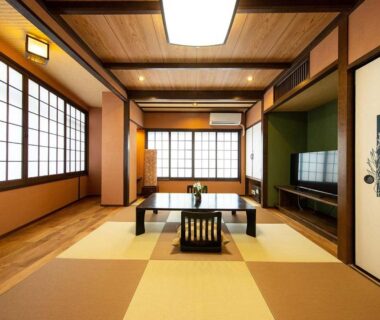 Traditional tatami room with low table and shoji screens at Ryokan Kiraku in Ōita, Kyūshū