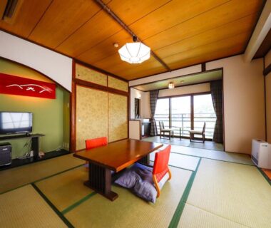 Traditional tatami room with low table, zabuton cushions, shoji screens and balcony at Ryokan Kiritani Hakoneso, Kanagawa