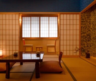 Japanese tatami room with low wooden table, floor cushions, shoji screens and alcove seating at Ryokan Kohro Kyoto