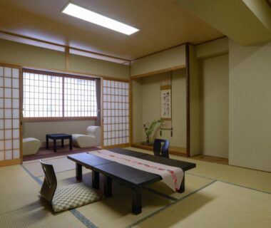 Traditional tatami room with low table, floor cushions, shoji screens and tokonoma at Ryokan Kohro Kyoto