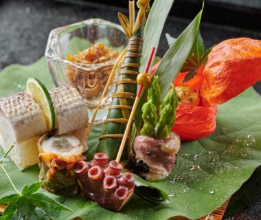 Seafood assortment with octopus, grilled fish and garnishes on a leaf platter at Ryokan Kohro Kyoto