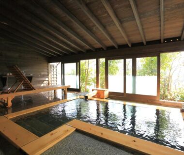 Wooden indoor onsen bath with large windows at Ryokan Kono-Yu, Kumamoto, Kyūshū