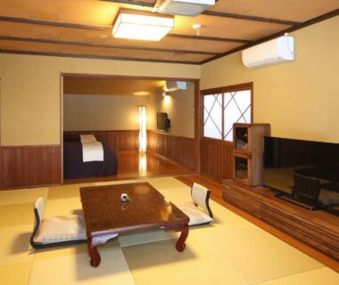 Spacious tatami room with low table and futon bedding at Ryokan Kono-Yu, Kumamoto, Kyūshū