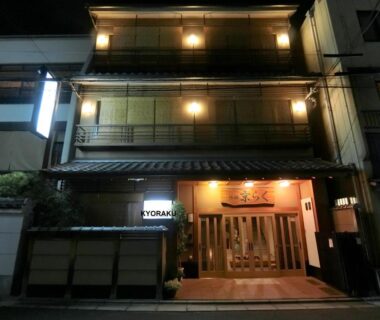 Exterior at night showing lit entrance and traditional facade of Ryokan Kyoraku in Kyoto, Kansai