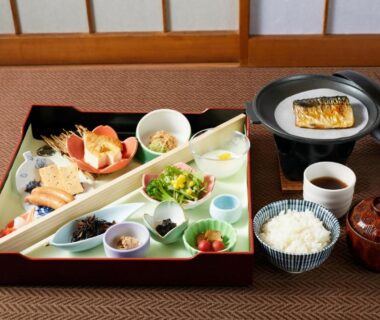 Assorted Japanese meal with grilled fish, rice, soup and small side dishes on tatami at Ryokan Matsushima, Kanagawa